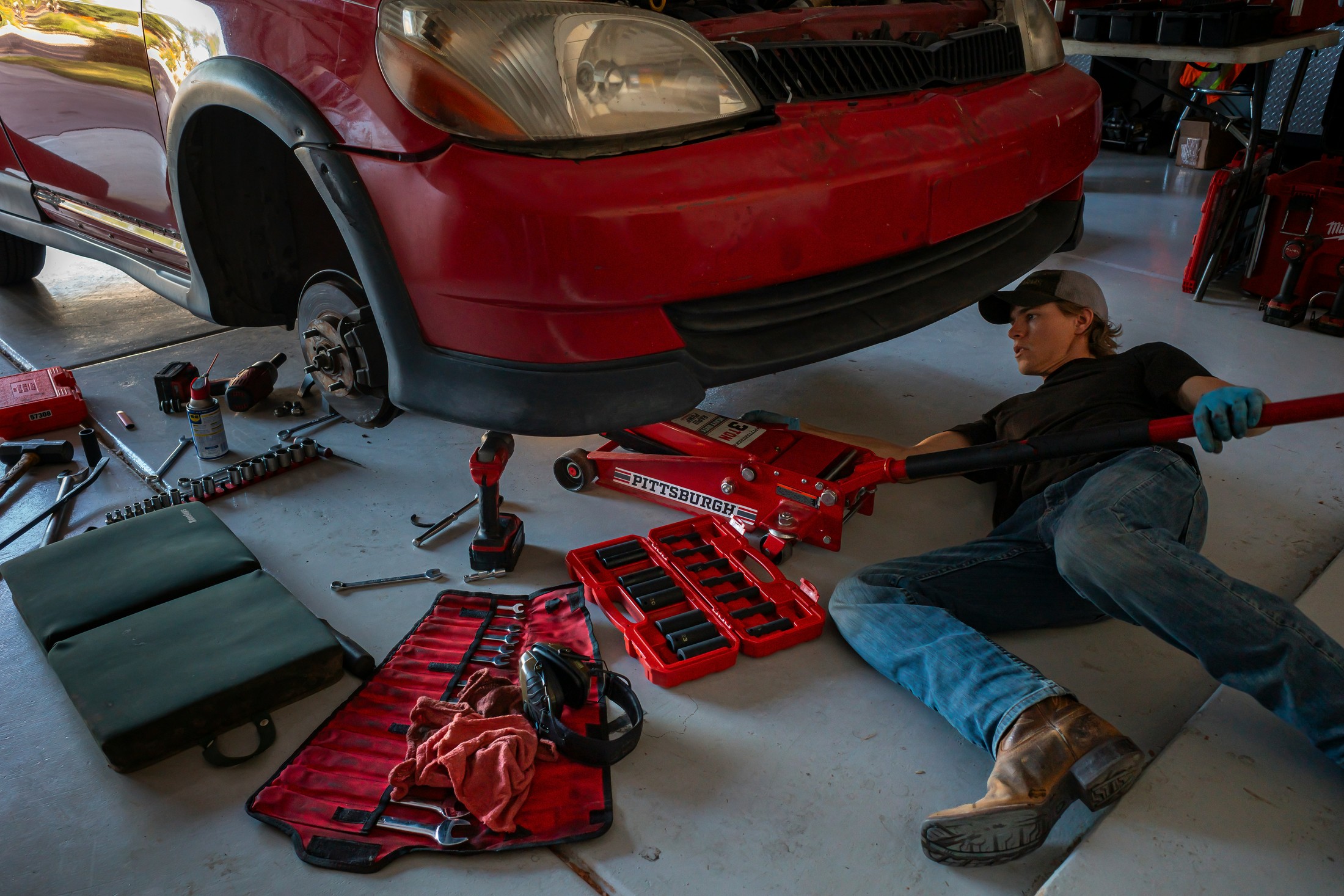 Technician repairing a vehicle in a professional automotive repair garage