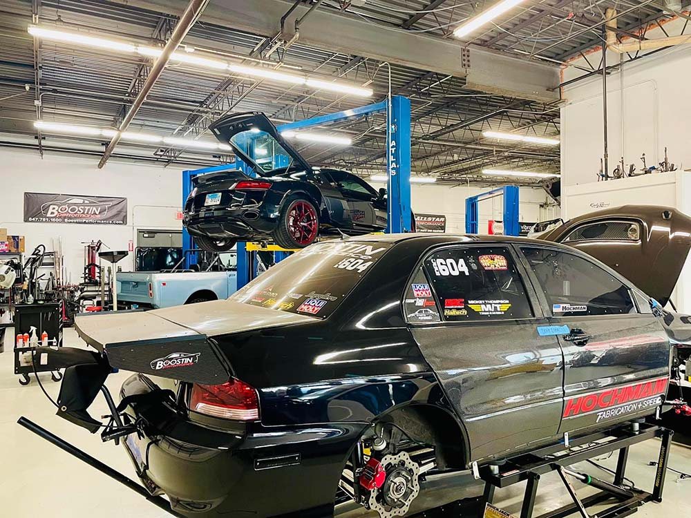 Performance and customized vehicles inside a professional automotive workshop