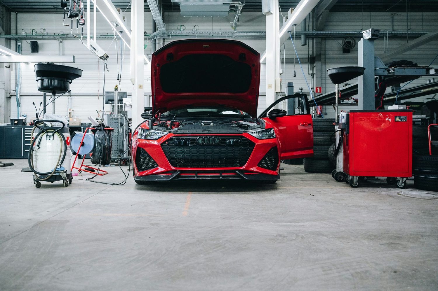 Performance and customized vehicles inside a professional automotive workshop