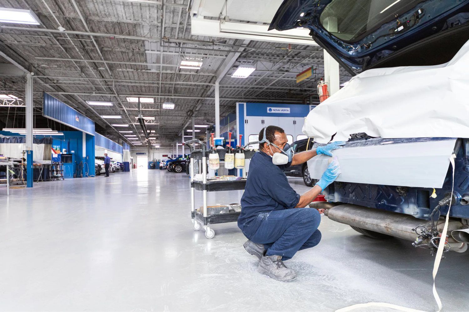 Technician repairing a vehicle in a professional automotive repair garage